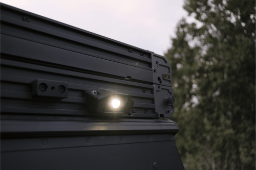 Light on a vehicle gfc camper with trees in the background