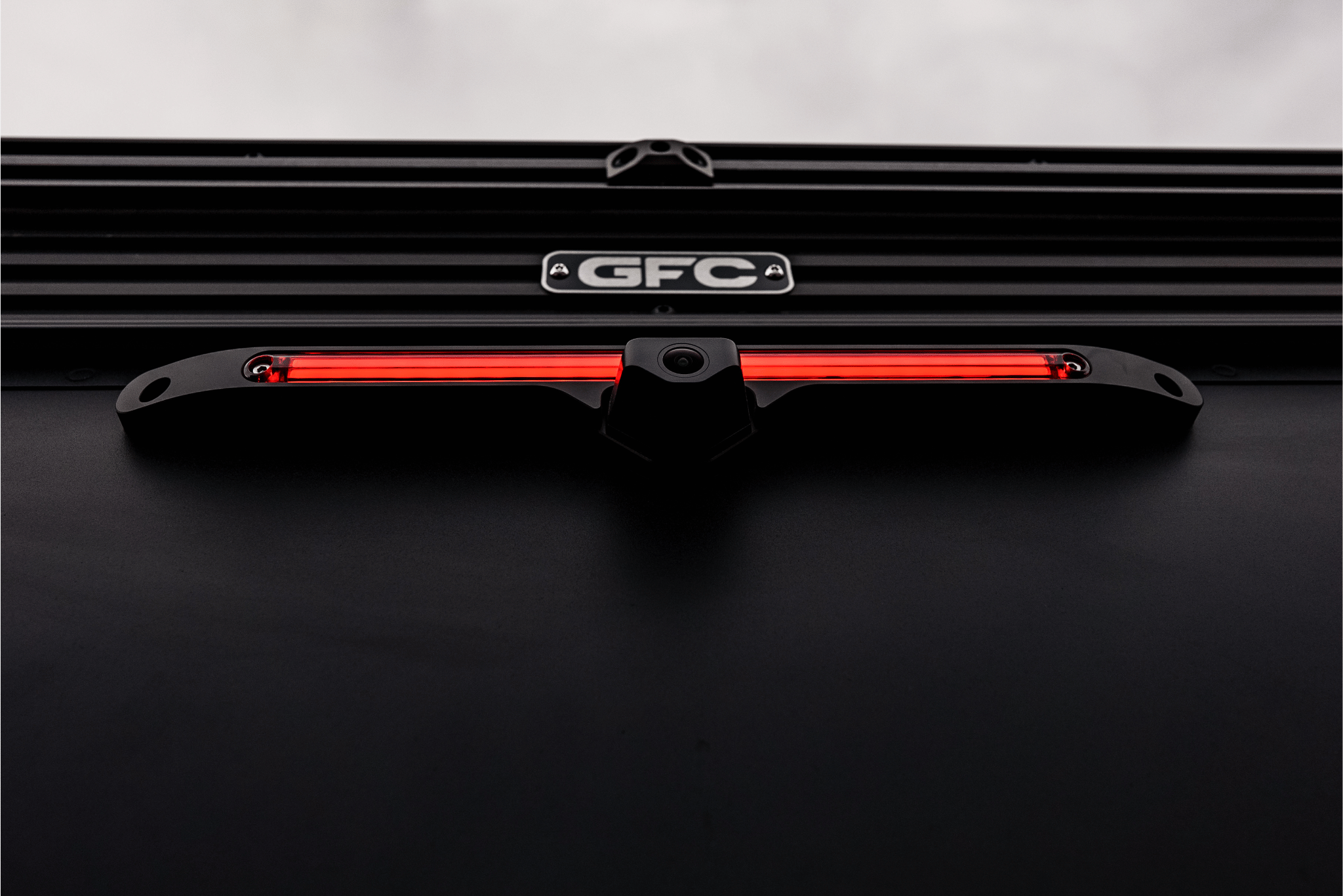Black car grille with red LED light bar and 'GFC' logo on a dark background